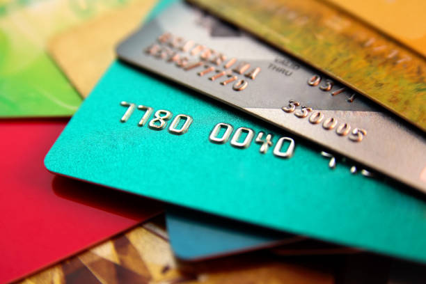 stack of multicolored credit cards, close up view with selective focus